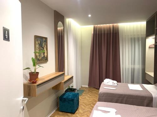 a hotel room with two beds and a mirror at Tirana Magnifique Apartments in Tirane