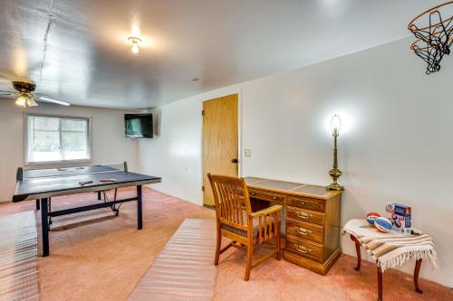 a room with a desk and a ping pong table at Lakefront Group Getaway with Dock in Baldwin! in Baldwin