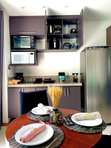 a kitchen with a table with two plates on it at Apart Praia de Icaraí London, Vista Cristo and MAC in Niterói