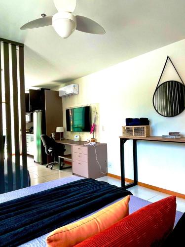 a bedroom with a bed and a desk with a computer at Apart Praia de Icaraí London, Vista Cristo and MAC in Niterói