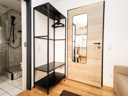 a room with a black book shelf next to a door at Hoffie und Prost in Hopfgarten im Brixental