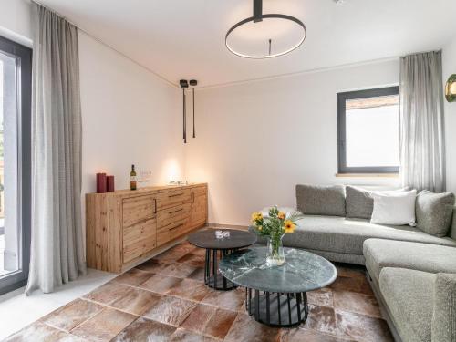 a living room with a couch and a table at Alpenlodge Pettneu Lodge 2 in Pettneu am Arlberg