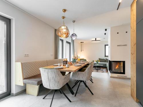 a dining room and living room with a table and chairs at Alpenlodge Pettneu Lodge 2 in Pettneu am Arlberg