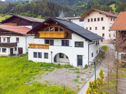 a house with a balcony on top of a hill at Alpenlodge Pettneu Lodge 2 in Pettneu am Arlberg