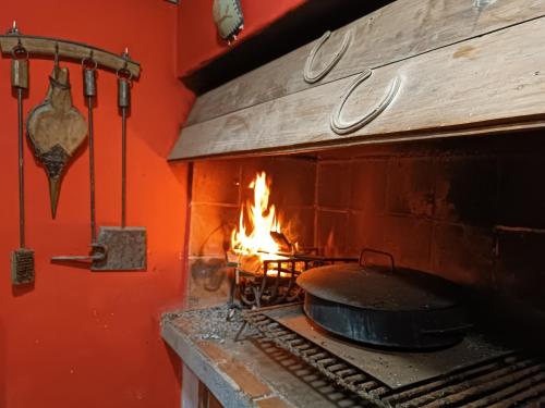 a stove with a pot and a fire in it at Samadhi in Tigre