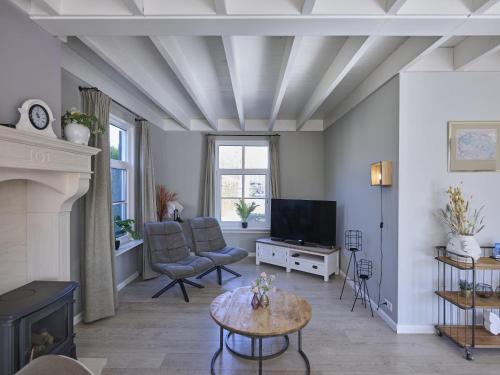 a living room with a couch and a tv at t Kaatsheuveltje 5 in Sprang-Capelle