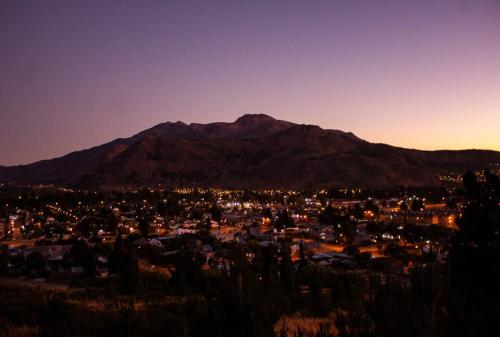 a view of a city with a mountain in the background at Refugio del Pescador in Esquel