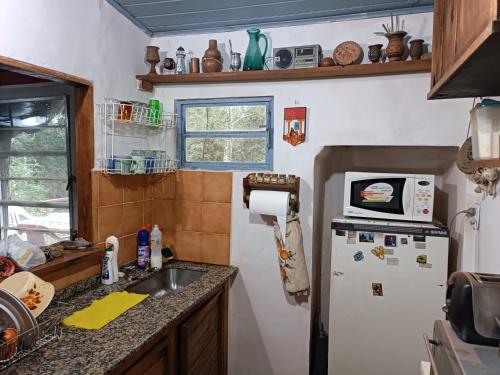 a kitchen with a refrigerator and a sink at Samadhi in Tigre