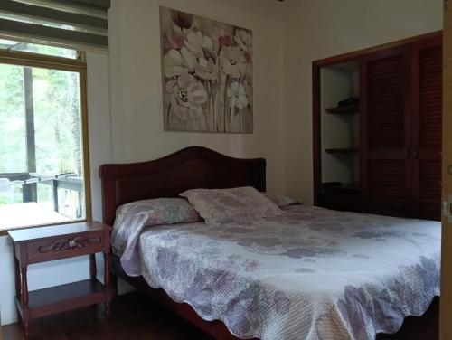 a bedroom with a bed and a window at Condominio Hacienda Shangrila in San Francisco
