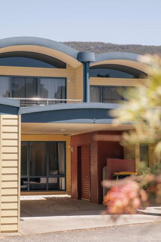 a large house with a blue roof at Halls Gap Escape Townhouses in Halls Gap