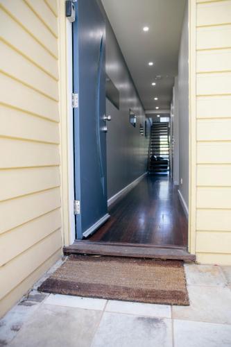 an empty hallway with a blue door on a house at Halls Gap Escape Townhouses in Halls Gap