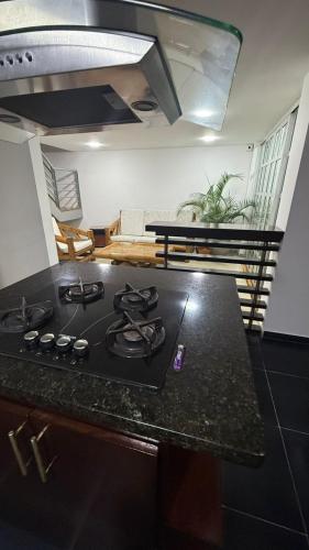 a kitchen with a stove top oven in a room at Hotel Villa María Coworking in Villavicencio
