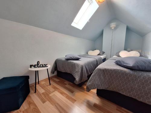 a attic bedroom with two beds and a skylight at Family friendly house with a swimming pool Praznica, Brac - 24570 in Pučišća