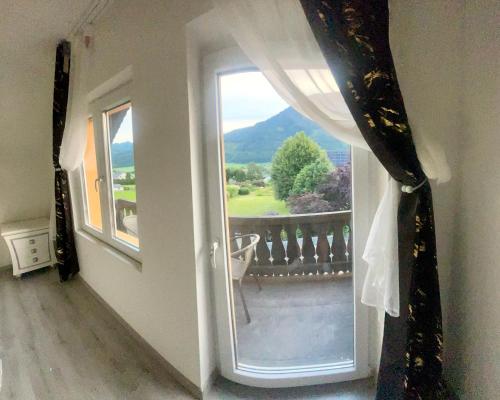a room with a window with a view of a balcony at Grüner See Hotel & Residenzen in Oberort