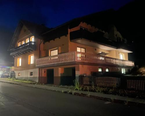 a building with a balcony on the side of a street at Grüner See Hotel & Residenzen in Oberort