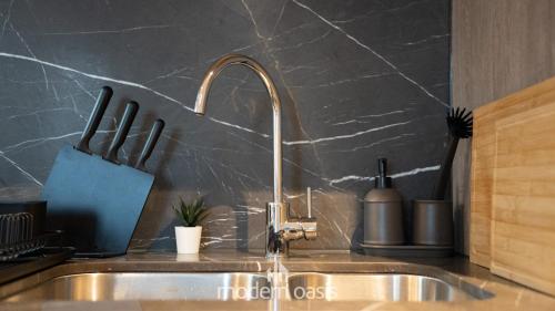a kitchen sink with a faucet and a counter at Modern CBD 2BR Free Gym & Pool Walk Everywhere in Melbourne