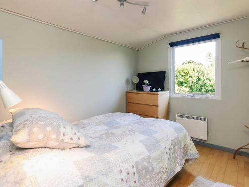 a bedroom with a bed and a window at 6 person holiday home in Bogø By in Bogø By