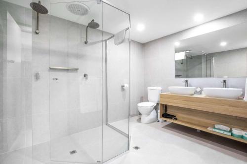 a bathroom with a glass shower and a toilet at Nightcap at Hotel Victor in Victor Harbor