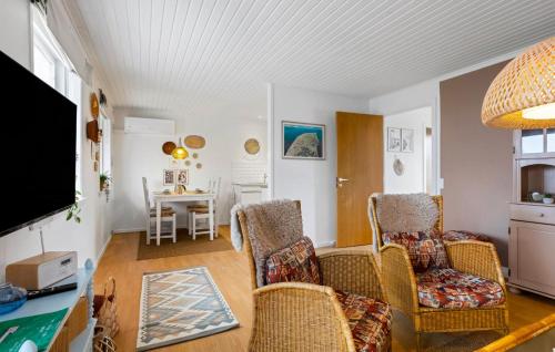 a living room with chairs and a table at 1 Bedroom Awesome Home In Skagen in Skagen