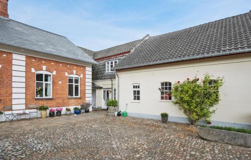 a courtyard of a house with two buildings at Two-Bedroom Apartment In Middelfart in Middelfart