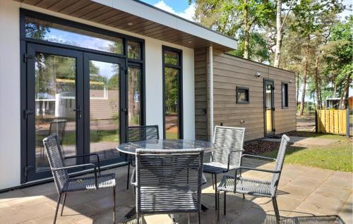 a patio with a table and chairs on a patio at 2 Bedroom Amazing Home In Hellendoorn in Hellendoorn
