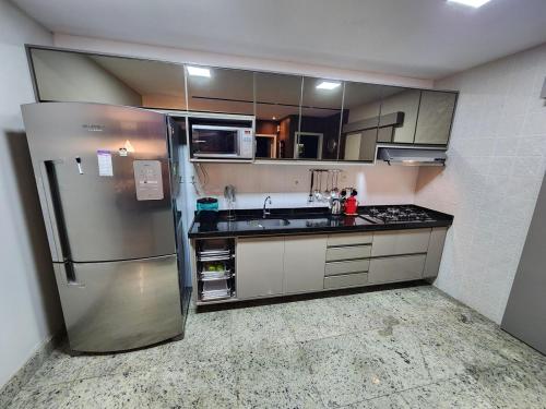 a large kitchen with a stainless steel refrigerator at High-Standard Home for COP30 in Belém-PA in Ananindeua