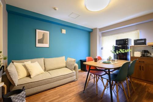 a living room with a couch and a table at Venture in Ōdōri
