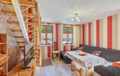 a living room with a couch and a staircase at Ferienwohnung Bodstedt in Bodstedt