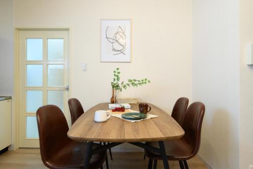 a dining room table with brown chairs around it at Verdant 601 in Ōdōri