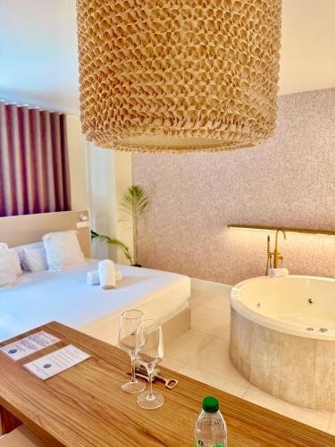 a hotel room with a bed and a bath tub at Reina Victoria Velázquez in Alicante