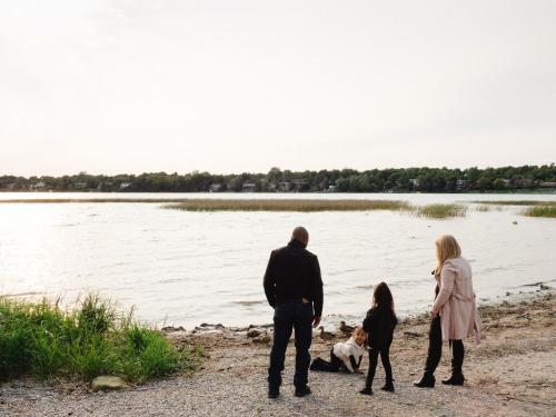 a family standing on the beach near the water at Holiday Inn Express Kingston Central by IHG in Kingston