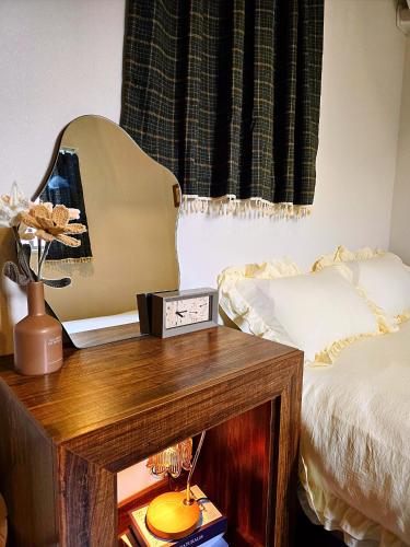a guitar sitting on a table next to a bed at Iriya House 上野 浅草すぐの一軒家貸切ステイ in Tokyo