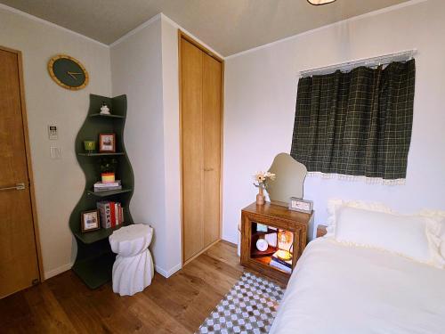a bedroom with a bed and a book shelf at Iriya House 上野 浅草すぐの一軒家貸切ステイ in Tokyo