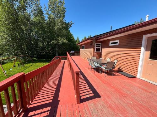 a wooden deck with a table and chairs on it at Cozy Palmer Retreat with Steam Sauna and Playground in Palmer