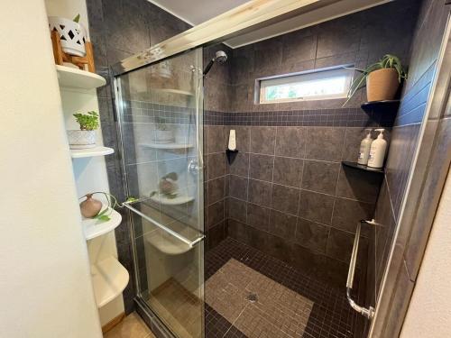 a shower with a glass door in a bathroom at Cozy Palmer Retreat with Steam Sauna and Playground in Palmer