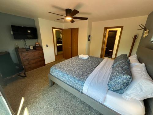 a bedroom with a bed and a ceiling fan at Cozy Palmer Retreat with Steam Sauna and Playground in Palmer