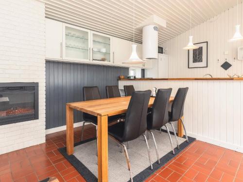 a dining room with a table and chairs and a fireplace at Holiday home- Free Water Park Access in Middelfart
