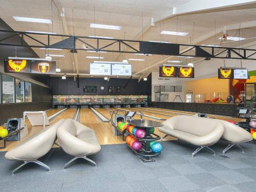 a bowling alley with pins and balls on the lanes at Type 10- Ho Holiday Centre holiday home in Blåvand