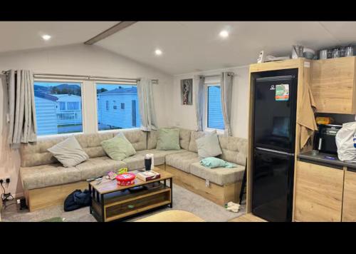 a living room with a couch and a refrigerator at Veez Dream in Prestatyn