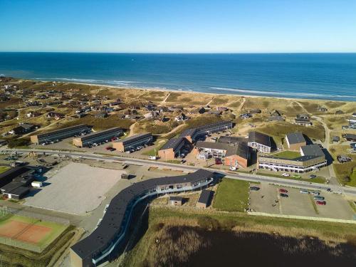 an aerial view of a parking lot next to the ocean at 4 person holiday home in Ringkøbing in Ringkøbing