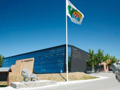 a flag on a pole in front of a building at Cozy 2-Person Apartment- Type 8 in Blåvand