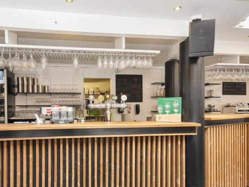 a bar in a restaurant with a counter at Holiday home with sauna, whirlpool- Type1 in Blåvand