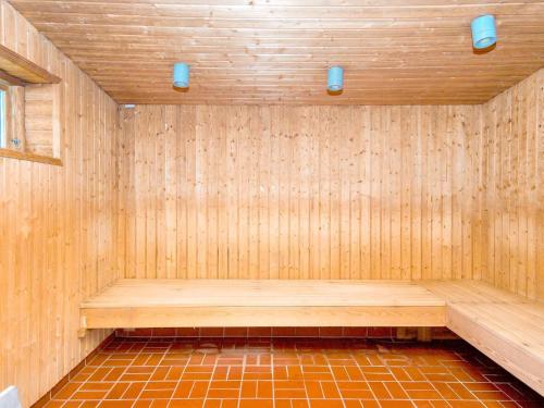 a sauna with a wooden bench in a room at Premium room on a holiday park in Gilleleje in Gilleleje