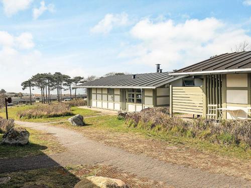 a house with a dirt road in front of it at Premium room on a holiday park in Gilleleje in Gilleleje