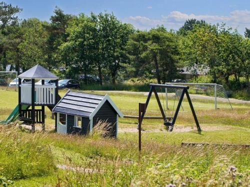 a playground with a play equipment in a field at Premium room on a holiday park in Gilleleje in Gilleleje