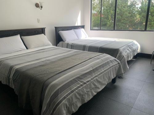 Postel nebo postele na pokoji v ubytování Latín Boutique