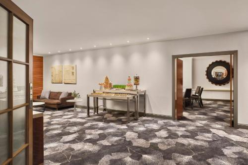 a living room with a table and a couch at Sheraton Grand Sydney Hyde Park in Sydney