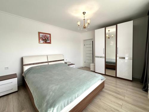 a bedroom with a bed and a dresser and a mirror at Дом в Бурабай in Borovoye