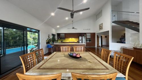 a kitchen and dining room with a table and chairs at Gallery Place in Caloundra West