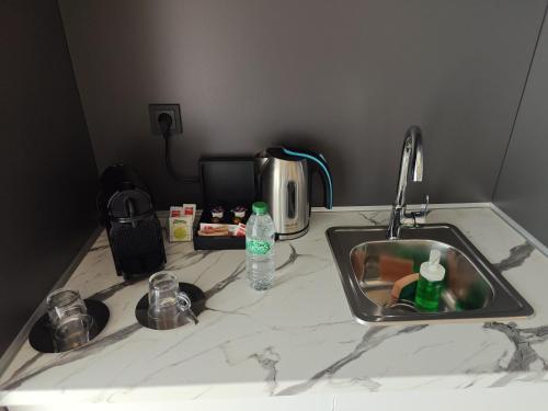 a kitchen counter with a sink and a bottle of water at Reina Victoria La Plaza in Alicante